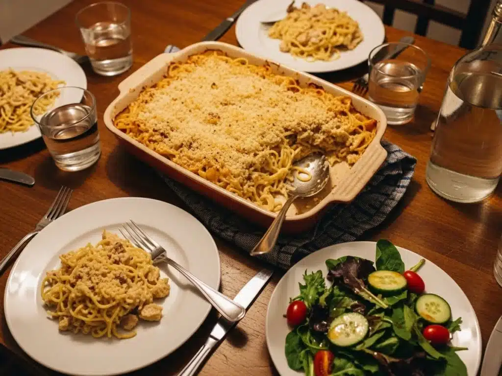 Turkey tetrazzini on a dinner table with salad for a weeknight meal