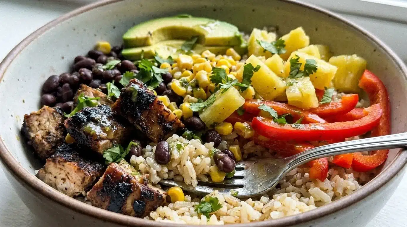 Delicious jerk chicken bowls with fresh vegetables and spices.